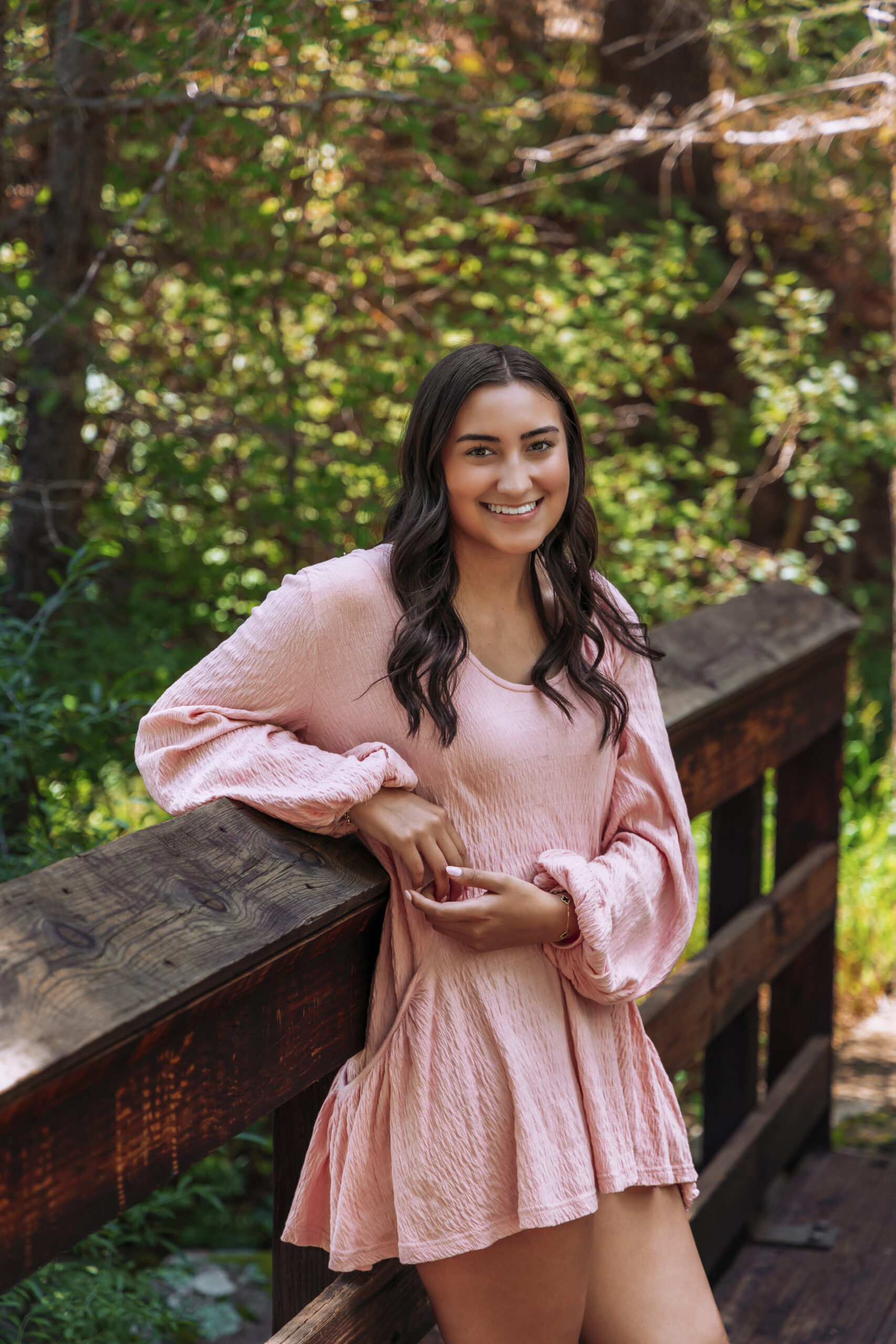 Senior photo by a stream.